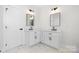 Bathroom with double sink vanity, modern fixtures, and white marble flooring at 4060 Steve Ikerd Ne Dr, Hickory, NC 28601