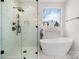 Modern bathroom with luxurious soaking tub, glass enclosed shower, and marble accents at 4060 Steve Ikerd Ne Dr, Hickory, NC 28601