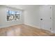 Bright bedroom featuring hardwood floors and large window overlooking neighborhood at 4060 Steve Ikerd Ne Dr, Hickory, NC 28601