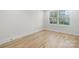 Cozy bedroom featuring hardwood floors and natural light from the large window at 4060 Steve Ikerd Ne Dr, Hickory, NC 28601