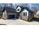 Beautiful new construction home with a gray brick facade, black trim, and a spacious concrete driveway at 4060 Steve Ikerd Ne Dr, Hickory, NC 28601