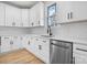 Bright white kitchen featuring stainless steel dishwasher, black hardware, and quartz countertops at 4060 Steve Ikerd Ne Dr, Hickory, NC 28601