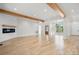 Spacious living room featuring hardwood floors, wooden beams, and a modern fireplace at 4060 Steve Ikerd Ne Dr, Hickory, NC 28601