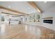 Bright, open living space with hardwood floors, white walls, exposed beams, and a modern fireplace at 4060 Steve Ikerd Ne Dr, Hickory, NC 28601