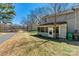 Backyard view featuring a screened-in porch and the home's exterior, with lawn and some trees at 4139 N Course Dr, Charlotte, NC 28277