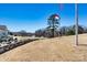 Picturesque golf course view with flags, a lake with fountain and surrounding trees on a sunny day at 4139 N Course Dr, Charlotte, NC 28277
