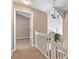 Well-lit hallway featuring neutral walls, carpeted floor and a white stair railing at 4139 N Course Dr, Charlotte, NC 28277