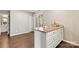 Kitchen island boasting granite countertops and white cabinets with modern silver drawer pulls at 4139 N Course Dr, Charlotte, NC 28277