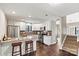 Modern kitchen with white cabinets, stainless steel appliances, granite countertops, and a cozy breakfast bar at 4139 N Course Dr, Charlotte, NC 28277
