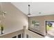Lofted living room area featuring a window, ceiling fan, and wood floors at 4139 N Course Dr, Charlotte, NC 28277