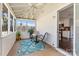 Inviting screened-in sunroom with a ceiling fan, table, chairs, and a view into the updated kitchen at 4139 N Course Dr, Charlotte, NC 28277