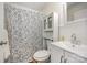 Bathroom with a floral shower curtain and white cabinetry at 421 N Tradd St, Statesville, NC 28677