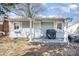 Charming single-story home featuring light blue siding and a cozy front porch area at 421 N Tradd St, Statesville, NC 28677