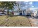 Quaint home with light blue siding, a cozy front porch, and well-maintained landscaping at 421 N Tradd St, Statesville, NC 28677