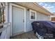 Cozy front porch with light blue siding and a grill covered to protect it from the elements at 421 N Tradd St, Statesville, NC 28677