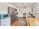 Well-lit kitchen featuring stainless steel appliances, white cabinetry, and a cozy dining area at 421 N Tradd St, Statesville, NC 28677