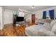 Spacious living room featuring beautiful hardwood floors, a sectional sofa, and stylish decor at 421 N Tradd St, Statesville, NC 28677