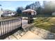Spacious backyard featuring a wooden deck with gazebo, black railings, and stone paver walkway at 4219 Robinwood Dr, Charlotte, NC 28212