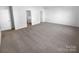 Large bedroom featuring neutral carpet, freshly painted walls, and access to ensuite bathroom and closet at 4219 Robinwood Dr, Charlotte, NC 28212