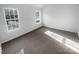 This bedroom is bright and airy with two windows and plush carpeting at 4219 Robinwood Dr, Charlotte, NC 28212