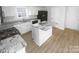Kitchen with island, granite countertops, stainless appliances and ample cabinet space at 4219 Robinwood Dr, Charlotte, NC 28212