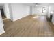 A spacious living room featuring sleek flooring, a fireplace, and a front door at 4219 Robinwood Dr, Charlotte, NC 28212
