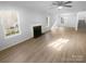 Open-concept living room with new flooring, a fireplace, and plenty of natural light at 4219 Robinwood Dr, Charlotte, NC 28212