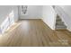 Bright living room with light wood floors, white walls, and natural light from the window at 4219 Robinwood Dr, Charlotte, NC 28212