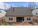 Back exterior view of the home featuring screened-in patio and partially fenced yard at 4720 Maiden Creek Way, Maiden, NC 28650