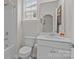 Bright bathroom with a large mirror, white cabinets, and a shower-tub combo at 4720 Maiden Creek Way, Maiden, NC 28650