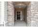 Covered front entrance features stone pillars, a decorated front door, and a welcoming atmosphere at 4720 Maiden Creek Way, Maiden, NC 28650