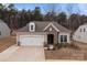 Inviting single-Gathering home showcases stone detailing, a two-car garage, and well-maintained landscaping at 4720 Maiden Creek Way, Maiden, NC 28650