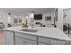 Modern kitchen island with a sink and seating offers a view to the living room and appliances at 4720 Maiden Creek Way, Maiden, NC 28650