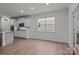 Open concept living room and kitchen with white cabinets and stainless steel appliances at 4720 Maiden Creek Way, Maiden, NC 28650