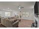 Spacious living room with wood floors, a ceiling fan, and large windows for natural light at 4720 Maiden Creek Way, Maiden, NC 28650