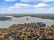 Stunning aerial view of a lake surrounded by colorful autumn trees and waterfront real estate at 5084 Mariana Ct, Tega Cay, SC 29708