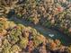 An aerial shot showcasing a home amongst the colorful fall foliage near a scenic golf course at 5084 Mariana Ct, Tega Cay, SC 29708