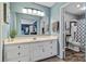 Well-lit bathroom featuring a double sink vanity with white cabinets and a view into an adjacent bathroom at 5084 Mariana Ct, Tega Cay, SC 29708