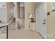 Inviting entryway featuring carpeted floors, stairway, and stylish accents including a table with a mirror above at 5084 Mariana Ct, Tega Cay, SC 29708