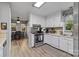 Bright kitchen with white cabinets, modern appliances, and adjacent breakfast nook at 5084 Mariana Ct, Tega Cay, SC 29708