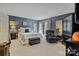 Stylish bedroom with modern decor, a comfortable bed, sitting area, and balcony access at 5084 Mariana Ct, Tega Cay, SC 29708