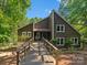 Charming home featuring a spacious wooden deck, beautiful landscaping, and a welcoming entrance at 5084 Mariana Ct, Tega Cay, SC 29708