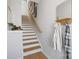 Bright staircase with wood treads and white risers, complemented by stylish wall decor and a mirror at 5723 Castlerea Dr, Charlotte, NC 28217