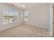 Well-lit bedroom featuring carpet floors, neutral paint, and bright windows at 620 Amethyst Cir, Fort Mill, SC 29708