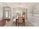Bright dining room featuring a wooden table with seating, complemented by elegant lighting and neutral decor at 620 Amethyst Cir, Fort Mill, SC 29708