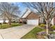 Brick home with a two-car garage, mature trees, and a well-maintained lawn, perfect for curb appeal at 620 Amethyst Cir, Fort Mill, SC 29708