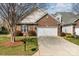 Charming brick home featuring a well-manicured lawn and a convenient two-car garage at 620 Amethyst Cir, Fort Mill, SC 29708