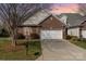 Charming brick home featuring a well-manicured lawn and a convenient two-car garage at 620 Amethyst Cir, Fort Mill, SC 29708
