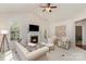 Bright living room with a fireplace, comfortable seating, and natural light from the windows and back door at 620 Amethyst Cir, Fort Mill, SC 29708
