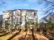 Backyard view featuring a wooden deck surrounded by mature trees and lush greenery at 6318 Pink Dogwood Ln, Charlotte, NC 28262